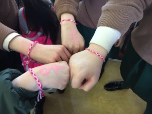 Student's hands displaying the female symbol.