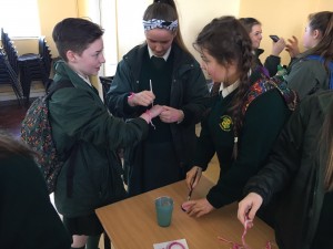 Hands and faces being painted on International Women's Day.