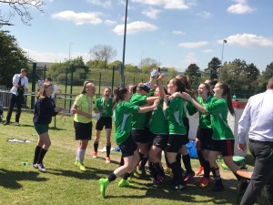 The team celebrate with their trophy