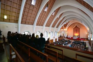 Shot of the choir singing to the congregation below.