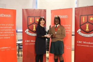 Ekenenna Chukwuewuzie being presented with her Best Speaker award by RTE's Keelin shanley.