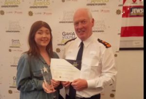 Erica Kiernan being presented with her Garda Youth Award by superintendent Kevin Gralton.