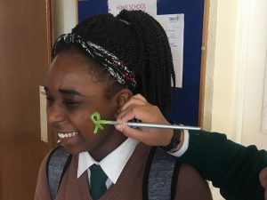 Facepainting green ribbons on world mental health day.