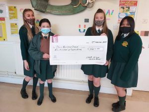 Emily O'Neill, Amy Richmond, Holly Gorman and Chloe Pingol holding the cheque for Down Syndrome Ireland.