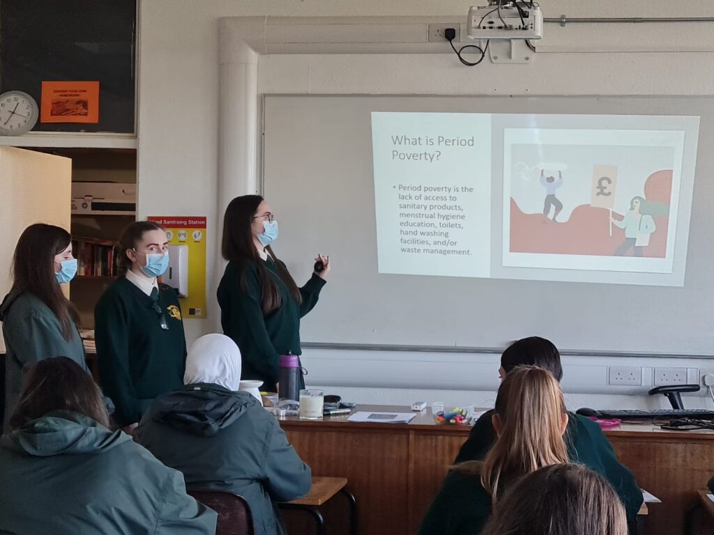 Faith Hurley, making a presentation to students on Period Poverty.